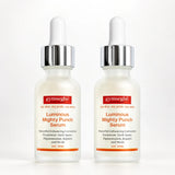Two identical bottles of gymseg·b¹ Luminous Mighty Punch Serum on a clean white background. The bottles are frosted glass with white droppers, silver caps, and red and orange labels.