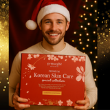 Man wearing a Santa hat holding a red box of gymseghe Korean Skin Care collection against a festive background.