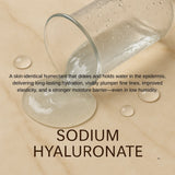 Glass container with water droplets on a beige background, featuring text about sodium hyaluronate.