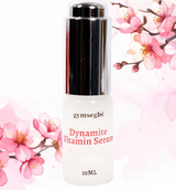 Gymsegbe Dynamite Vitamin Serum bottle with cherry blossom flowers on a white background