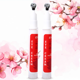 Two eye cream pumps with cherry blossom flowers in the background