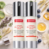Two bottles of Gymsegbe Luminous Mighty Punch Serum on a natural background with flowers and fruits.