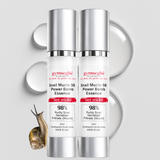 Two bottles of Gymsegbe Snail Mucin 98 Power Bomb Essence on a light gray background with a snail illustration.