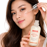 Woman applying Luminous Mighty Punch Serum to her face with a dropper.