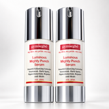 Two identical bottles of gymsegöe Luminous Mighty Punch Serum shown side by side on a clean white background. The bottles feature a reflective silver metallic cap and base with a cream-colored center label containing red and black text.