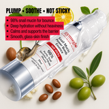 Gynseghe snail mucin power bomb essence bottle with snail, leaves, and olives on a light background