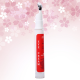 Eye cream bottle with red label on a pink floral background
