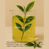 Beaker of green tea with leaves on a beige background
