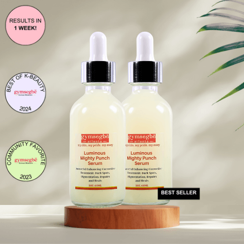 A bottle of Gymsegbe Luminous Mighty Punch Serum displayed against a background with floral elements, highlighting its skincare benefits.