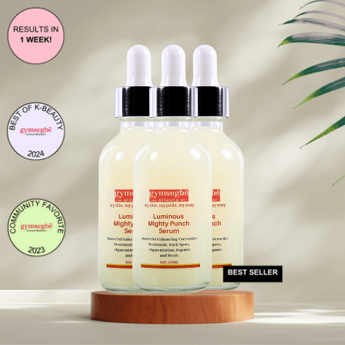A bottle of Gymsegbe Luminous Mighty Punch Serum displayed against a background with floral elements, highlighting its skincare benefits.