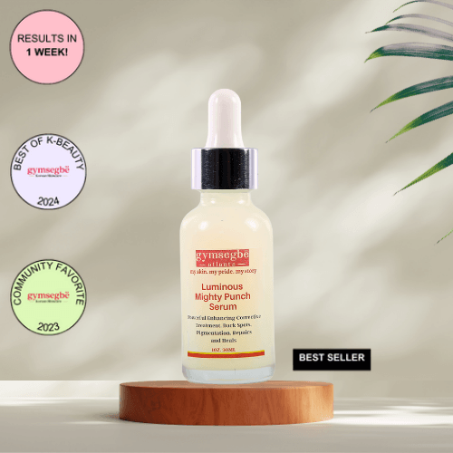 A bottle of Gymsegbe Luminous Mighty Punch Serum displayed against a background with floral elements, highlighting its skincare benefits.