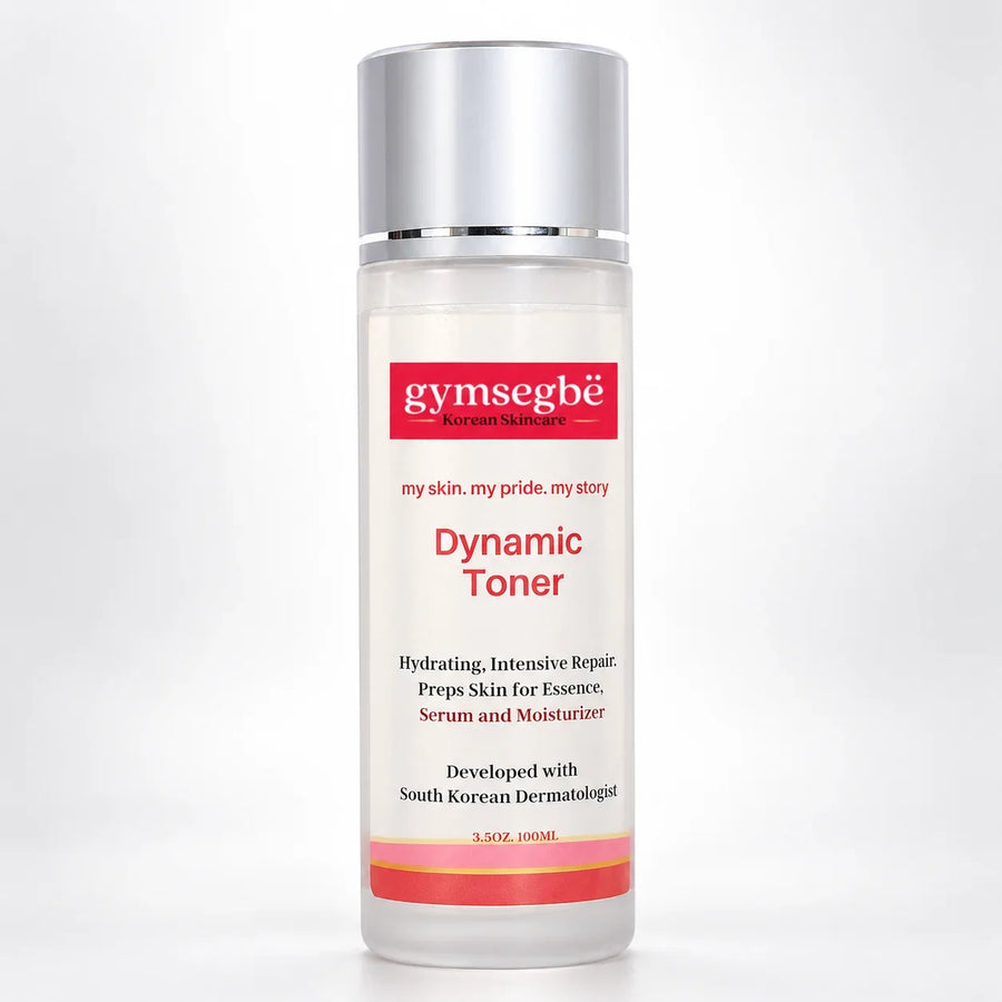 A 100ml bottle of gymsegbé Dynamic Toner on a light gray background. The bottle is clear with a white label featuring red and black text, and a metallic silver cap.