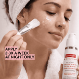 Woman applying skincare product with brush and gymseegbe glycolic lactic acid peel on a neutral background